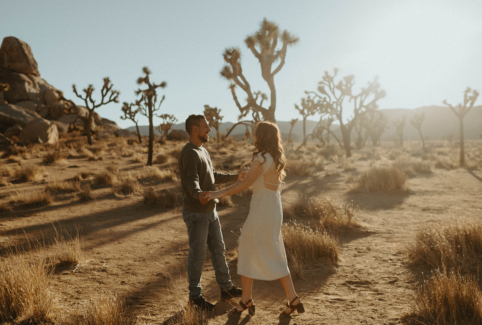 couple holding hands in Joshua tree