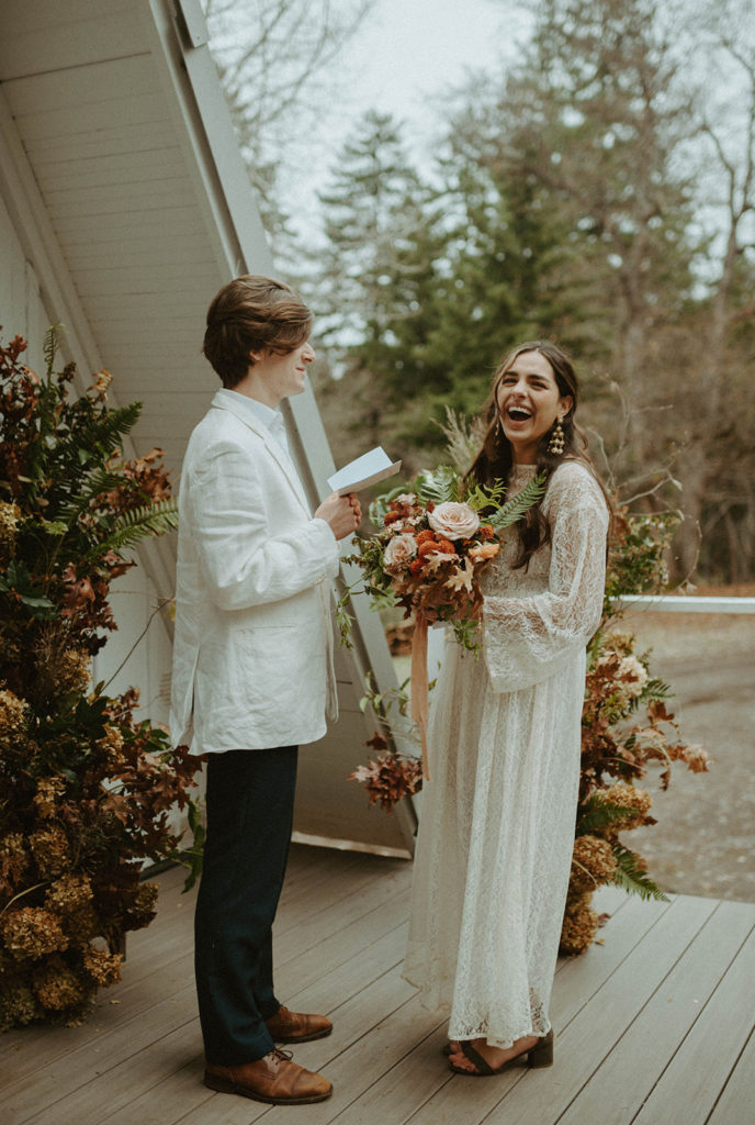 bride and groom at elopement ceremony in front of A fram cabin. Florist for Oregon Elopements