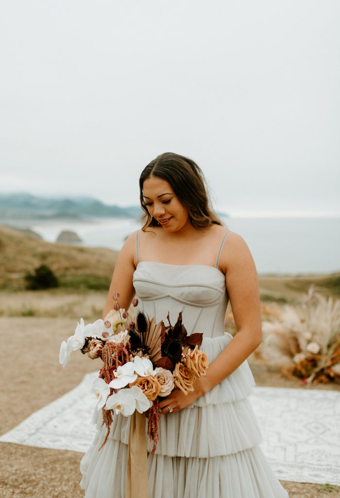 Bride in blue wedding dress and boho dried flower bouquet. Florist for Oregon Elopements