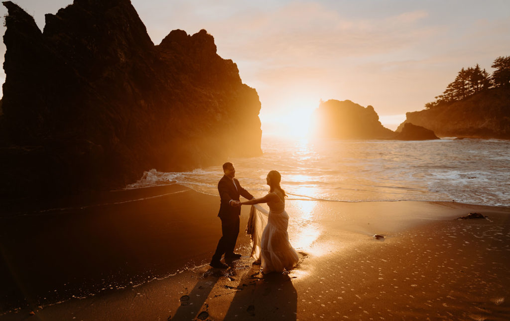 Sunset on the Oregon coast with bride and groom dancing