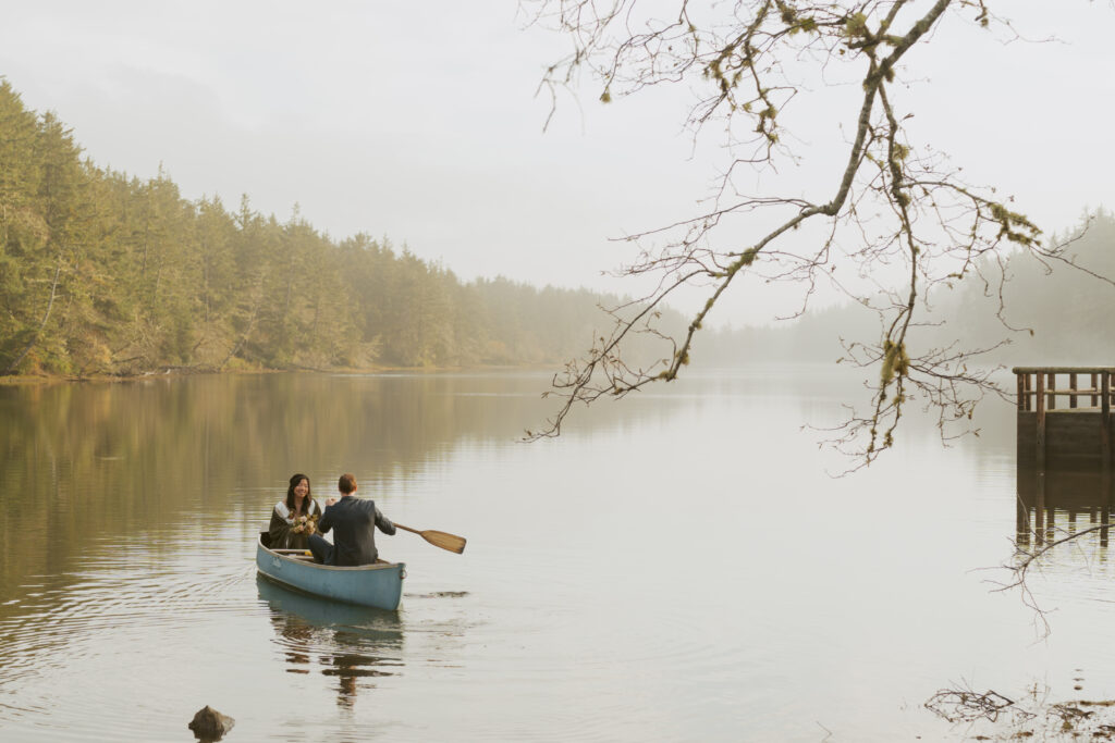 Sweet couple paddling across the lake for their dreamy elopement