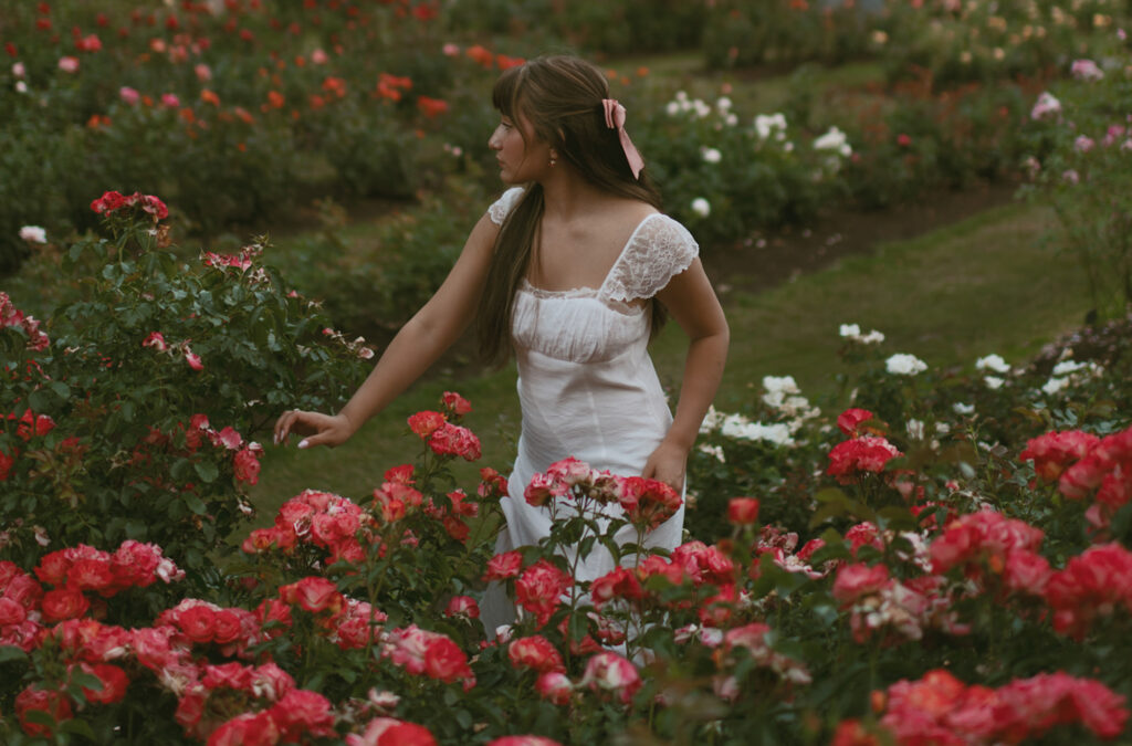 Young woman standing in a Rose Garden in Portland for her Senior picture session