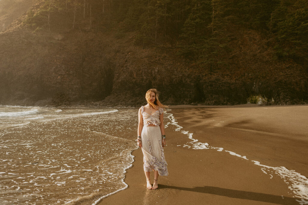 girl standing on beach in oregon