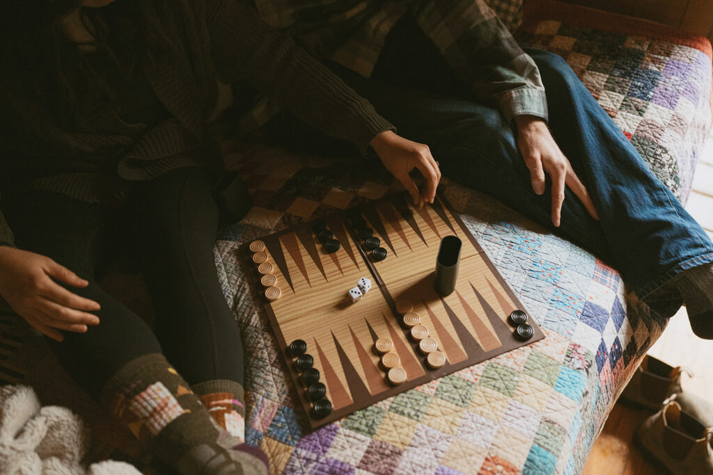 Couple enjoying a cozy game of backgammon during their private elopement