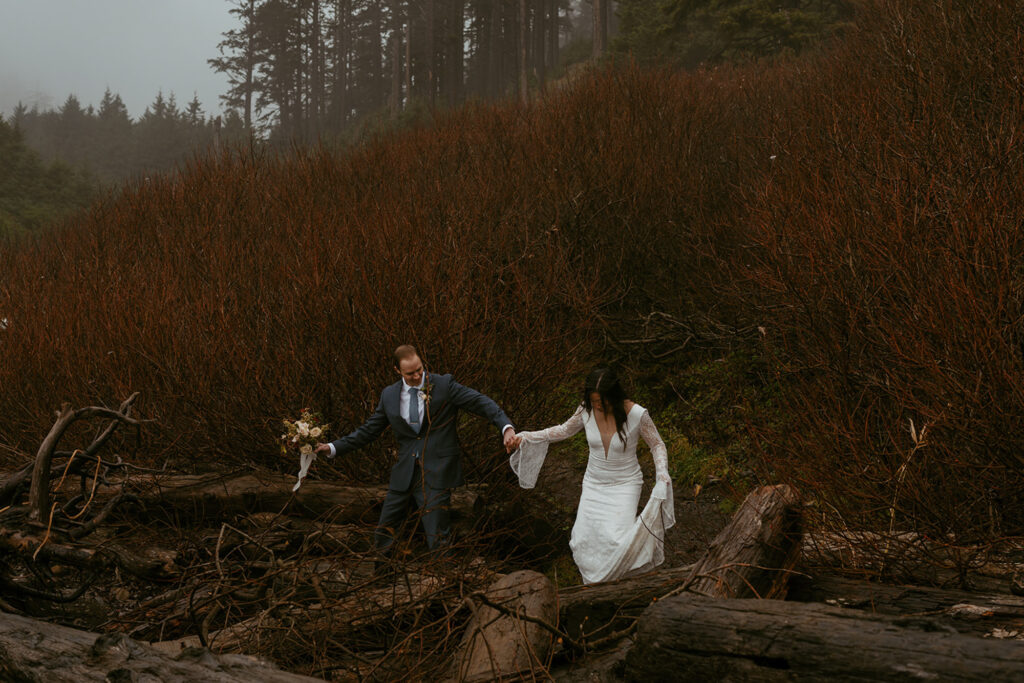 bride and groom walking over wood at the beach at Ecola State Park