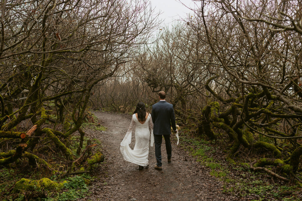 bride and groom walking through beachy forest at Ecola State Park