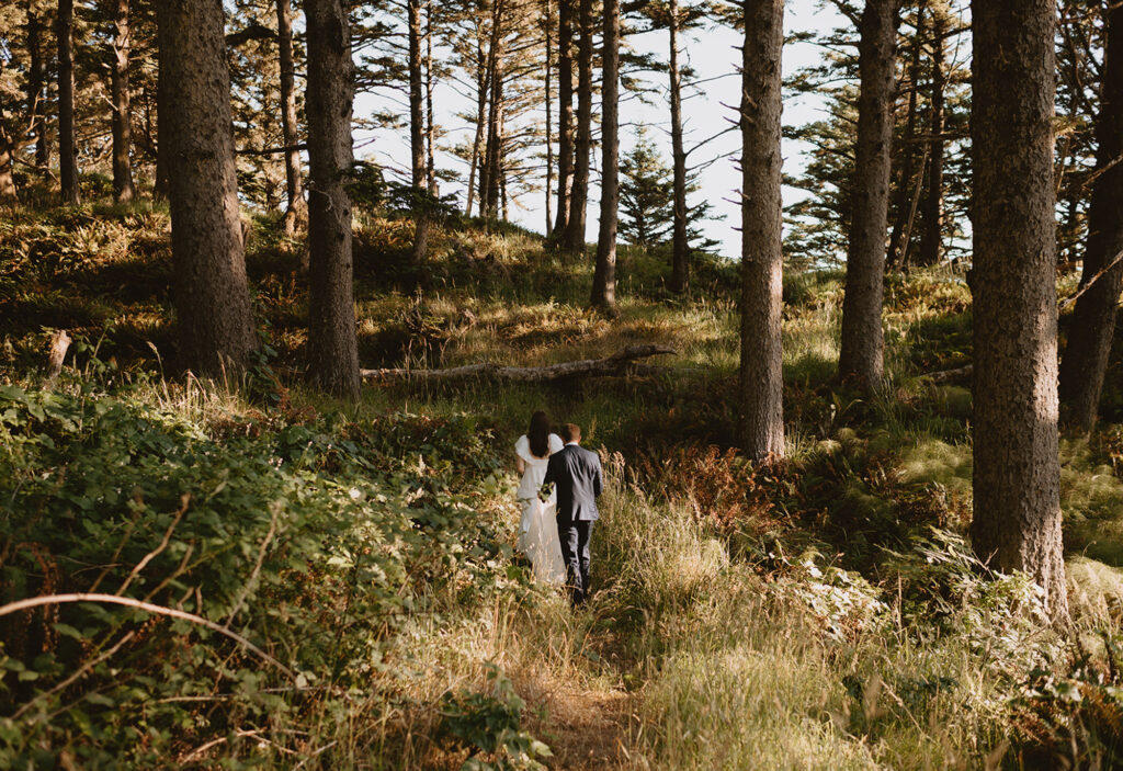 couple walking through the woods at Ecola State Park wedding