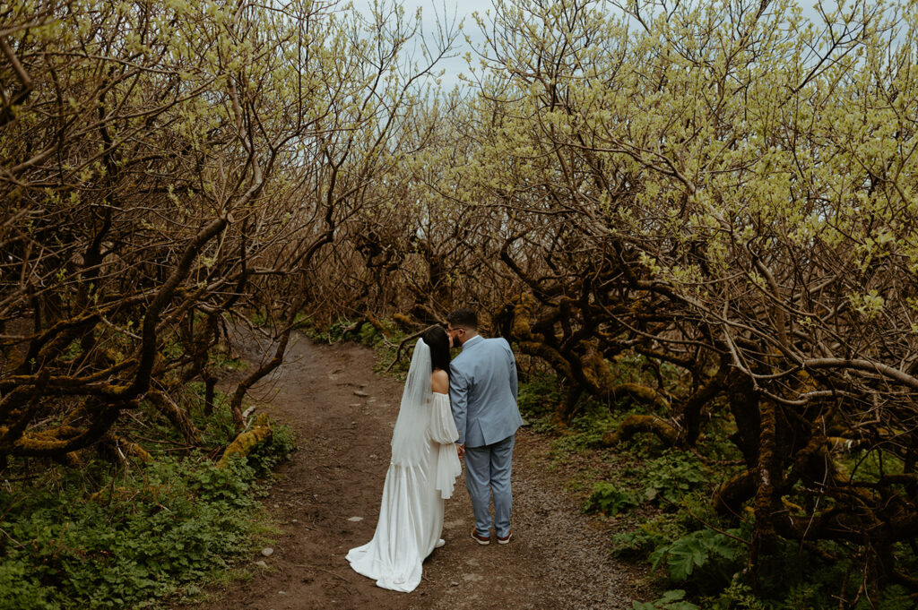 couple walking through woods at Ecola State Park