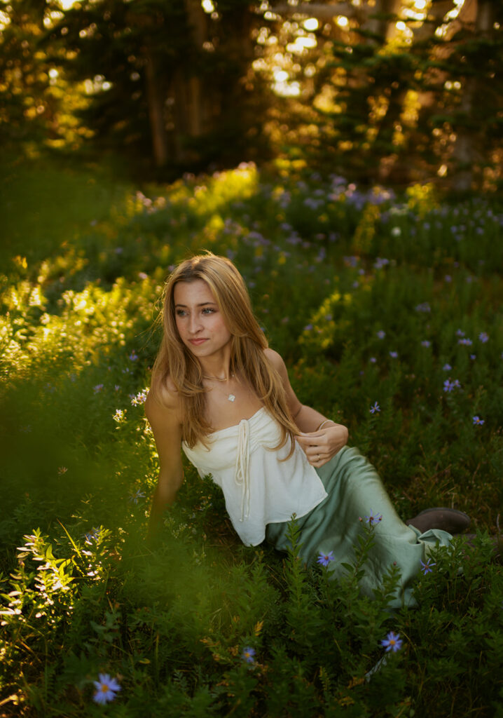 girl in white dress and skirt sitting in grassy area