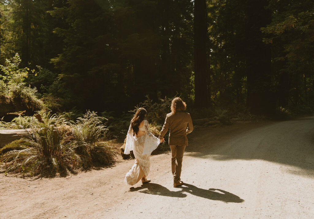bride and groom walking down a paved path together