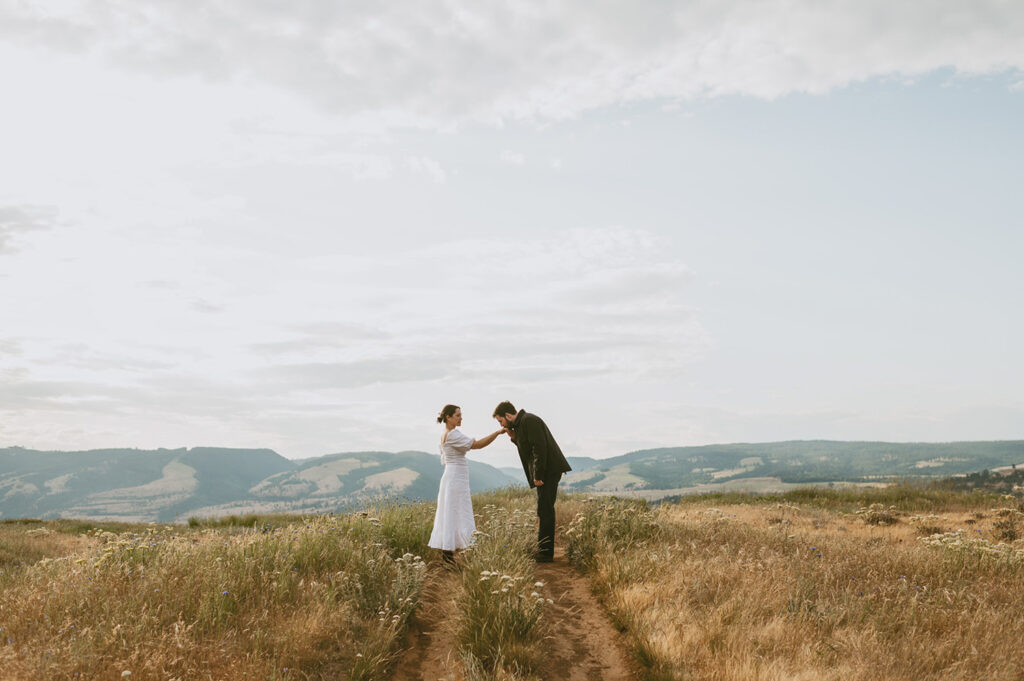 Couple sharing an intimate moment in a serene meadow during their elopement