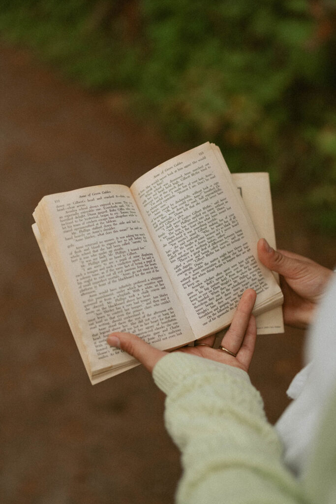 Close-up of hands holding a book open