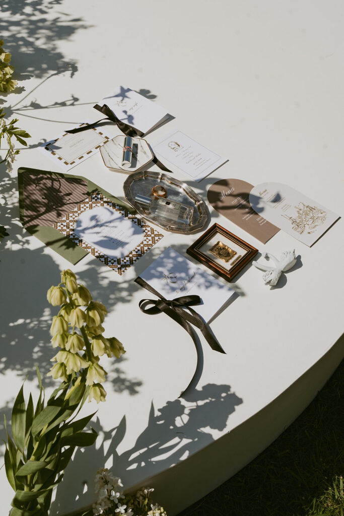 A table topped with a variety of objects and flowers.
