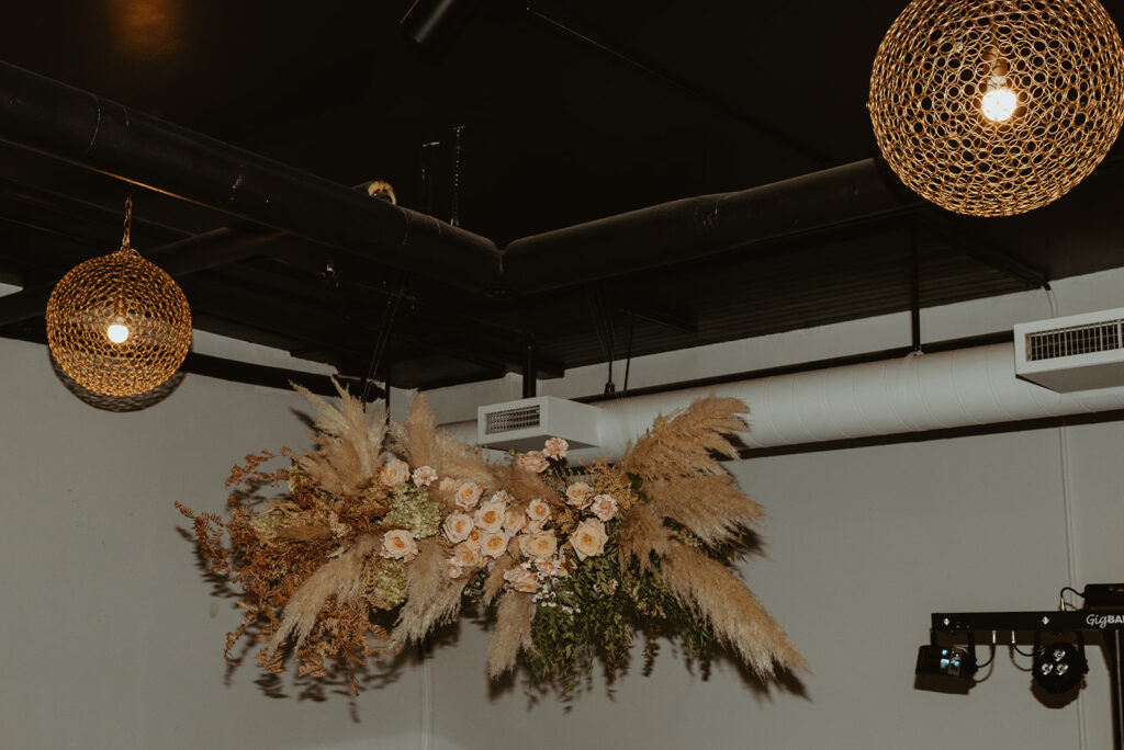 A bunch of flowers are hanging from the ceiling of a room.