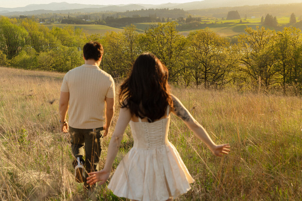 Woman following her partner through a golden meadow