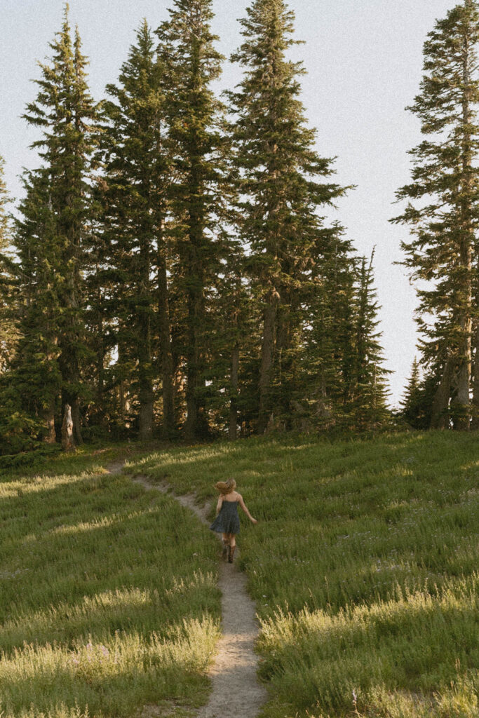 A person is walking down a path in the woods