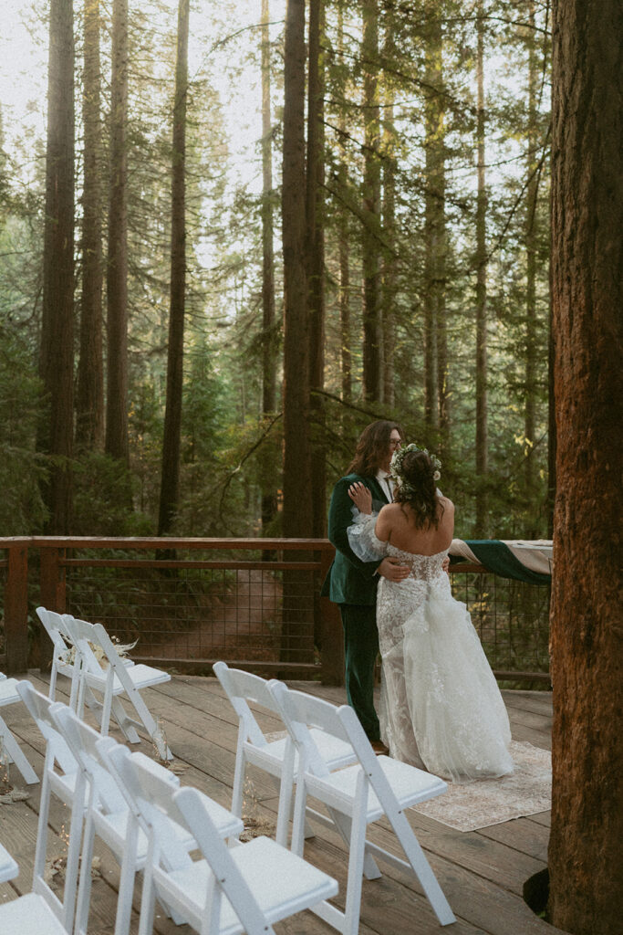 Bride and groom share a quiet moment alone on the ceremony deck at Hoyt Arboretum