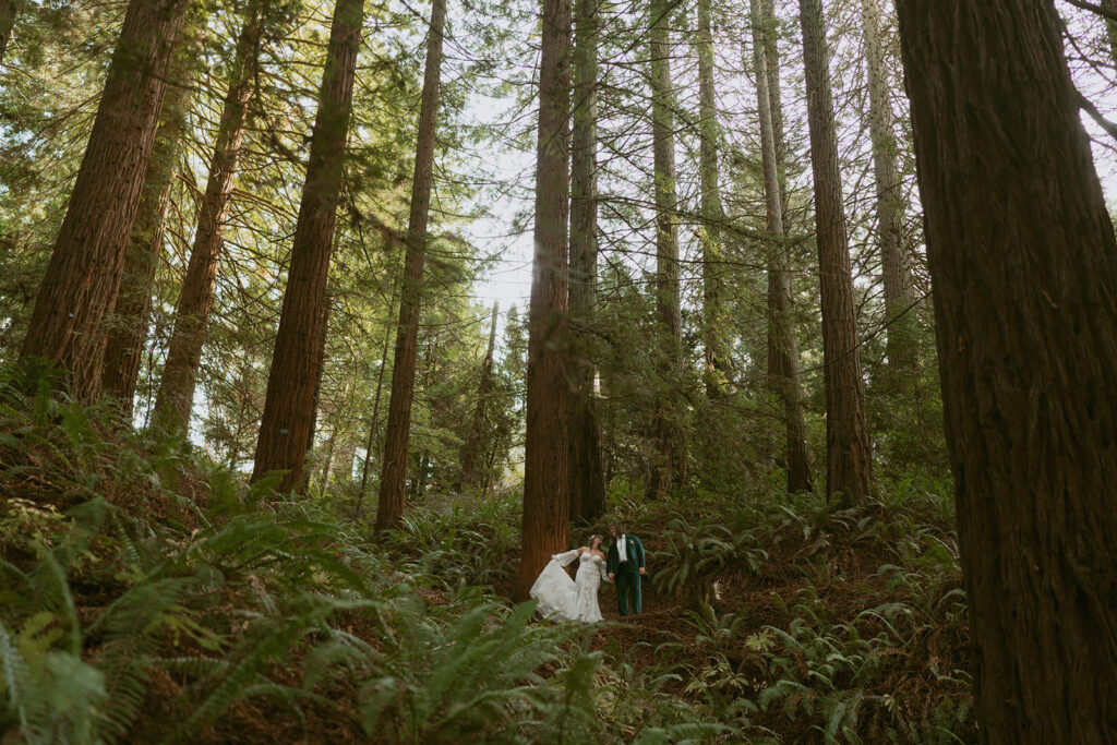 Bride and groom walking together in the woods