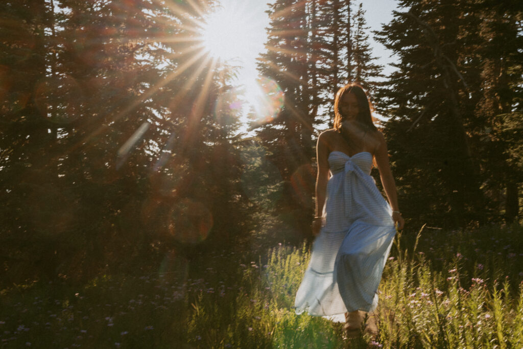 Woman backlit by golden sunlight through trees at Mt Hood