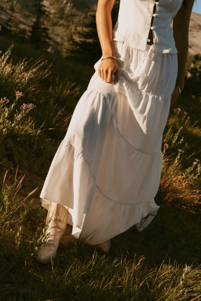 girl in white tiered maxi dress flowing in mountain wildflower meadow during Mount Hood photo session
