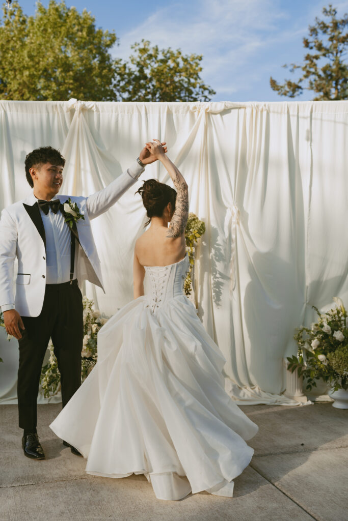 asian couple dance under white fabric wedding canopy at their micro wedding