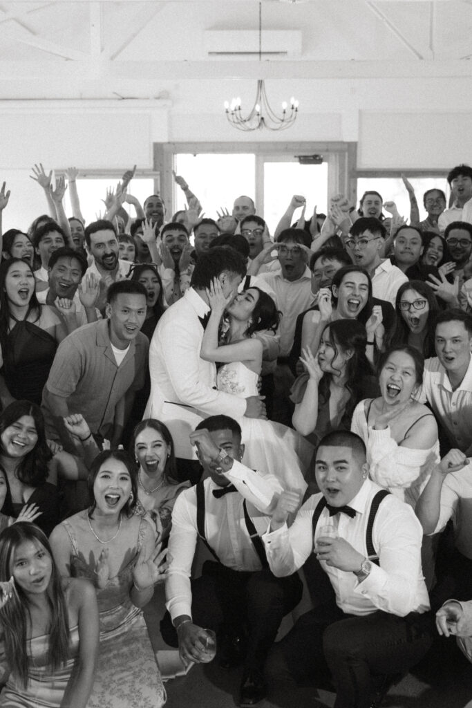 Wedding guests celebrate with raised hands at their micro wedding at Aurora Colony Vineyards