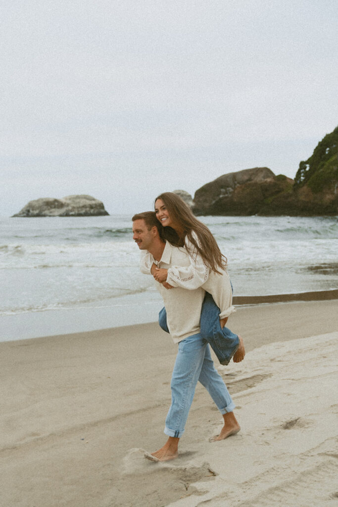 Brayden gives Jentrie a piggyback ride along the shoreline