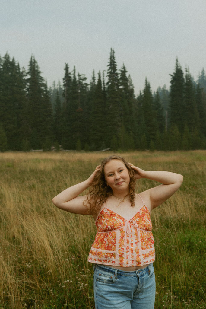 Woman smiling while holding her hair in a post