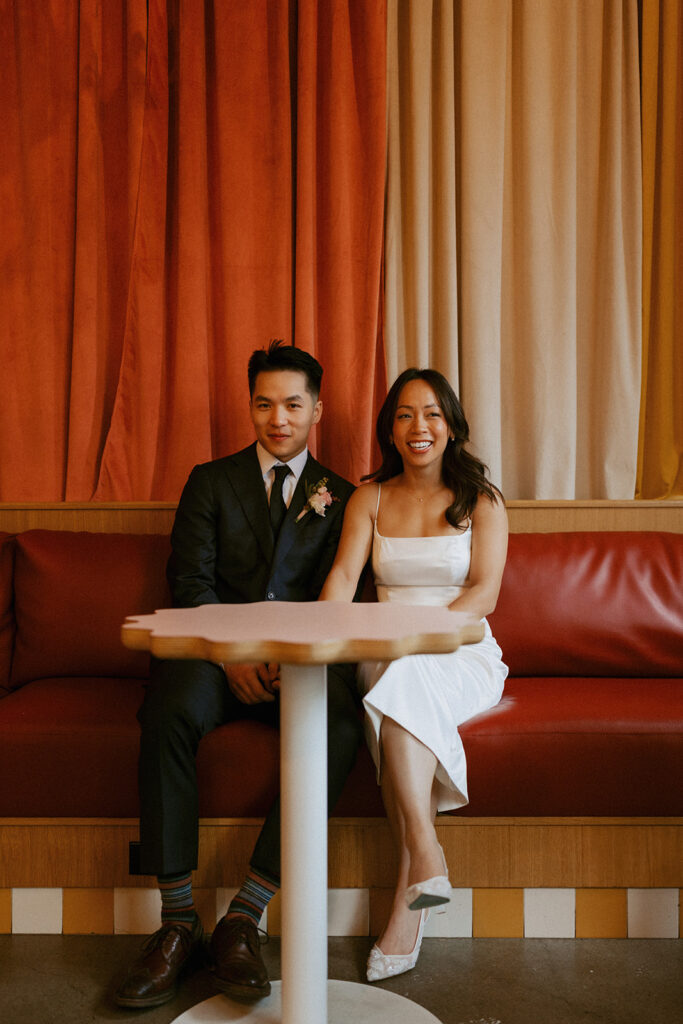 Bride and groom sitting together smiling