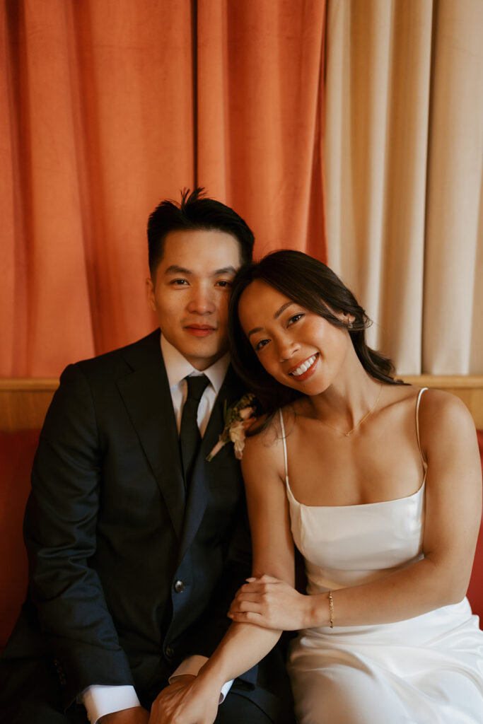 Bride and groom sitting close and smiling