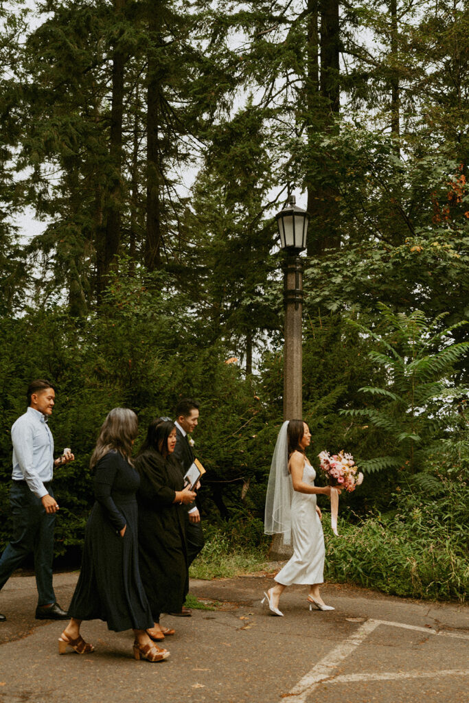 Bride walking with family before her Portland Oregon elopement ceremony.