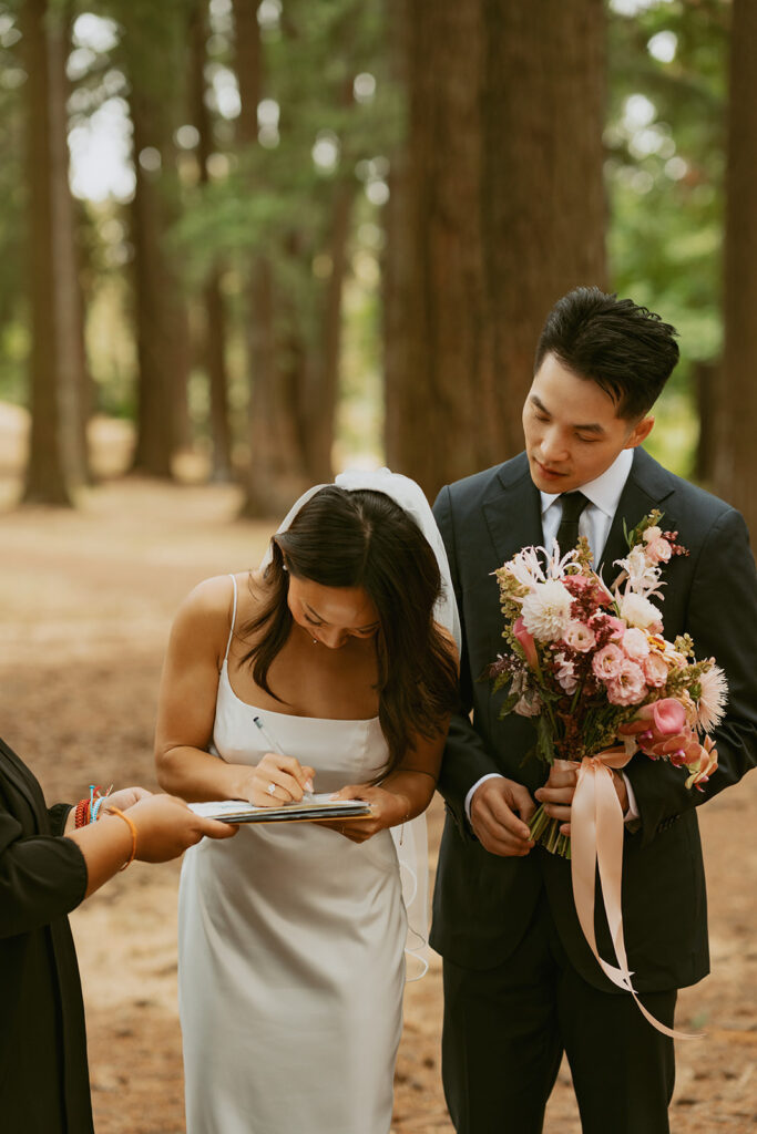 Bride signing marriage license at Portland Oregon elopement