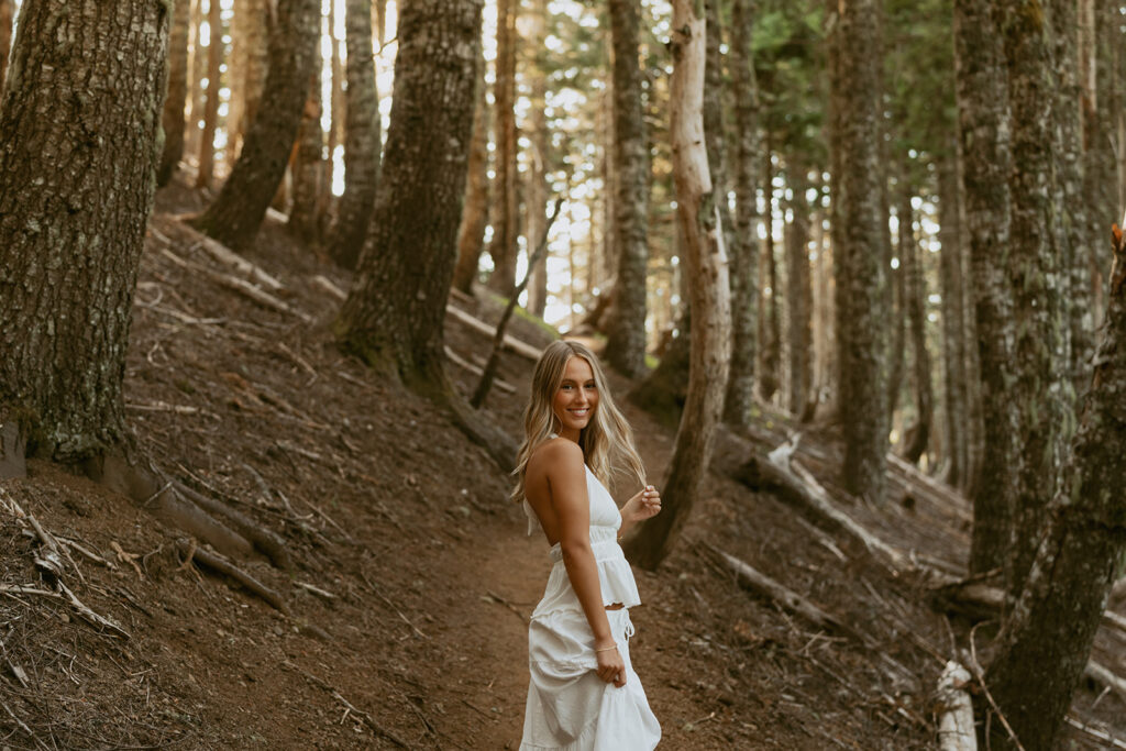 Senior portrait of girl walking through forest trail in Salem Oregon