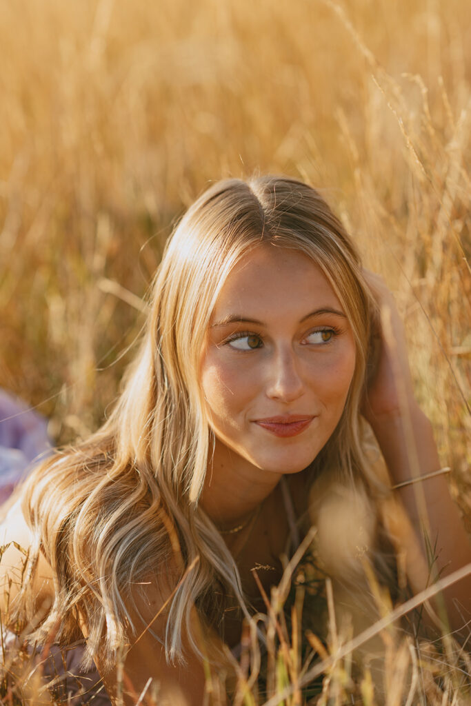 Close up senior portrait in golden grass during sunset in Salem Oregon