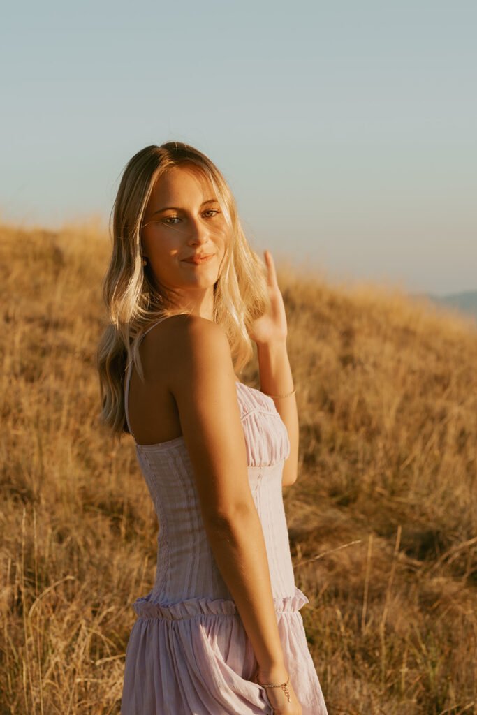 Salem Oregon senior photography standing in hillside meadow