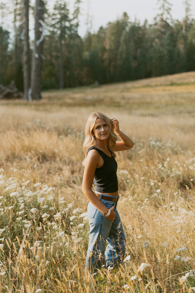 Oregon senior photography of a girl posing in a meadow with wildflowers