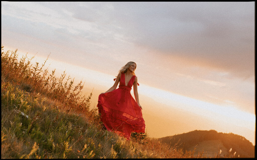 Salem Oregon senior photography of a girl in a red dress at sunset on a hillside