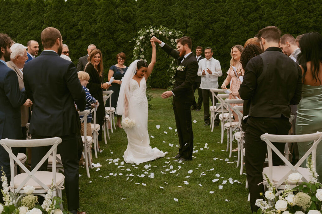 Bride and groom celebrating together after ceremony at backyard wedding venue