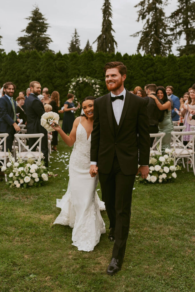 Bride and groom walking joyfully down the aisle