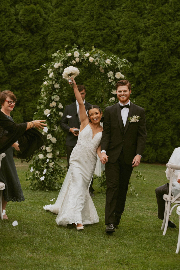 Bride and groom walking down wedding aisle