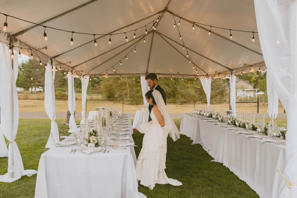Bride and groom looking at tented setup