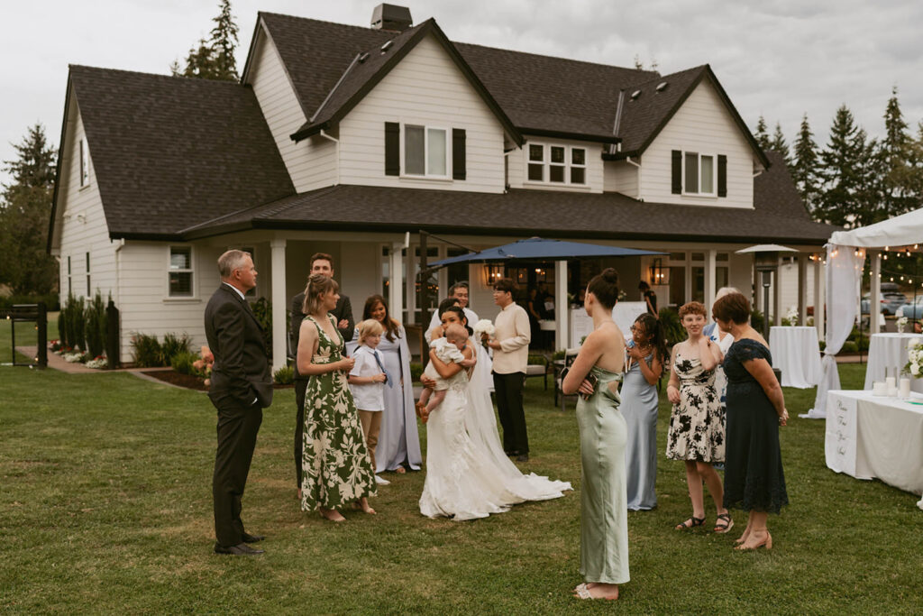 Guests talking outside house after ceremony