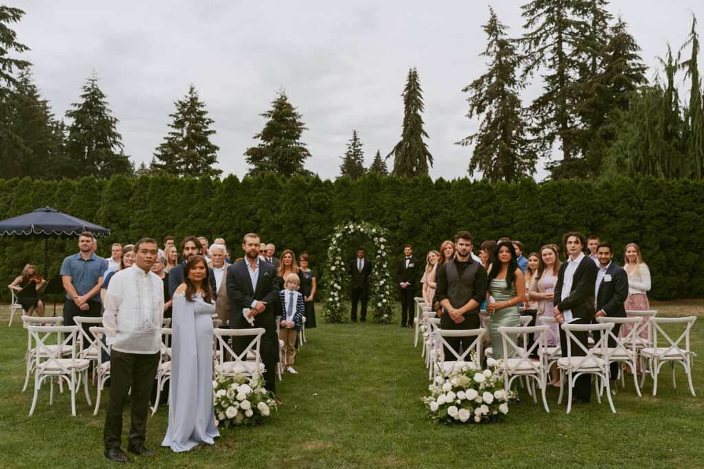 Guests standing before outdoor ceremony begins