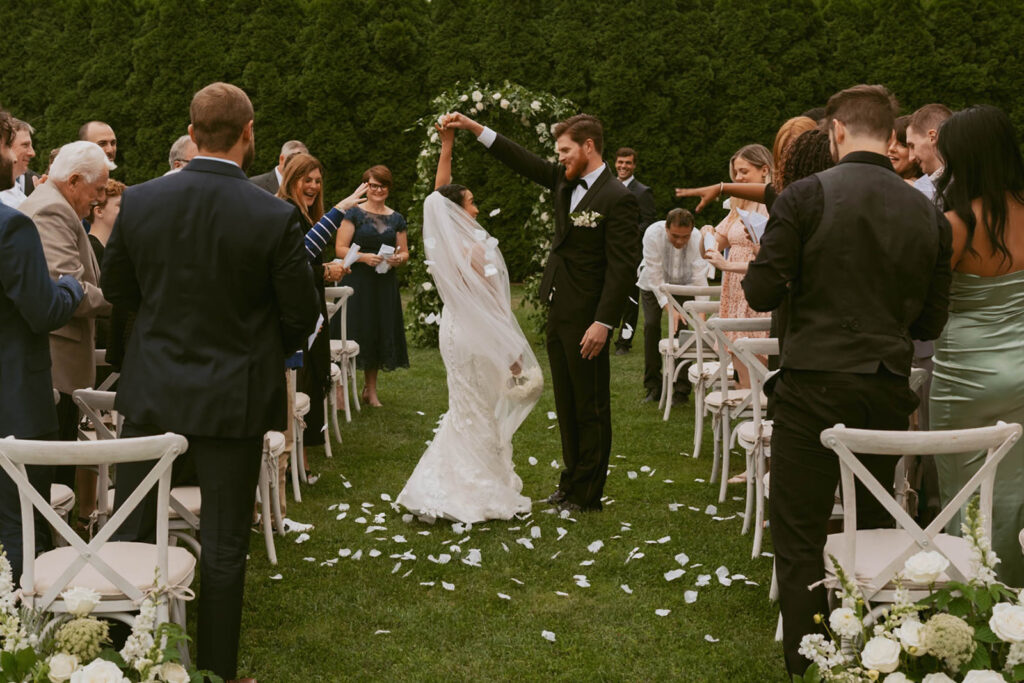 Bride and groom celebrating at outdoor ceremony