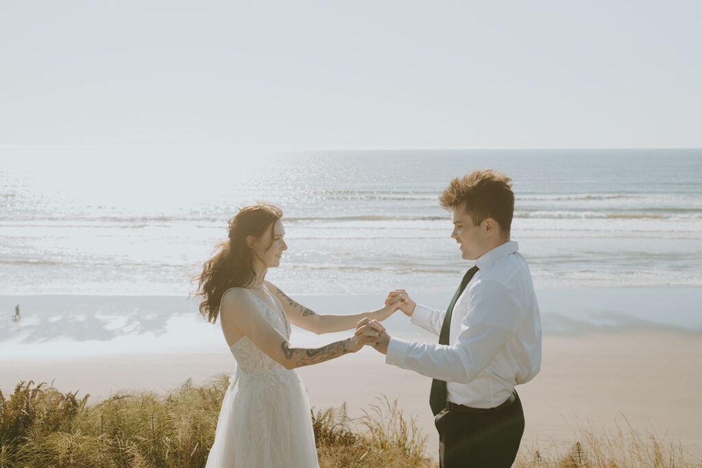 Couple dancing together with the ocean in the background