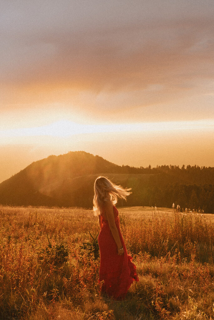 Senior walks through golden light on a hill