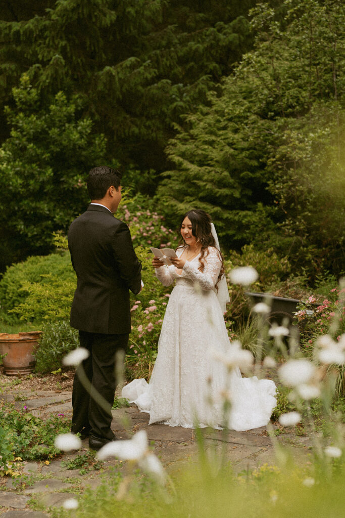 Bride reading vows to groom in a garden