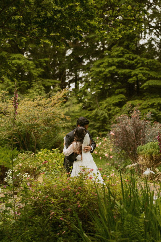 Couple hugging among garden flowers