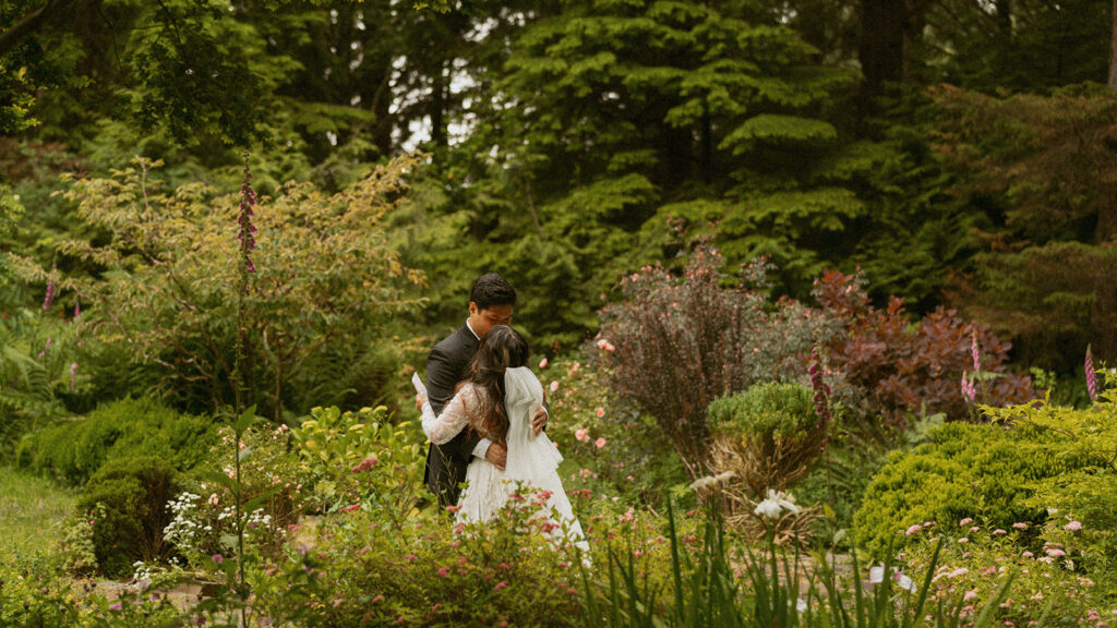 Couple embracing in a flower-filled garden