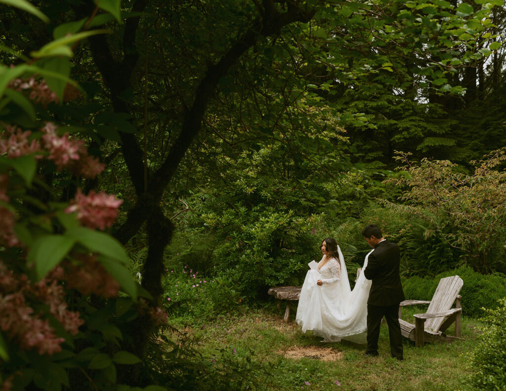 Bride and groom reading vows in a wooded garden